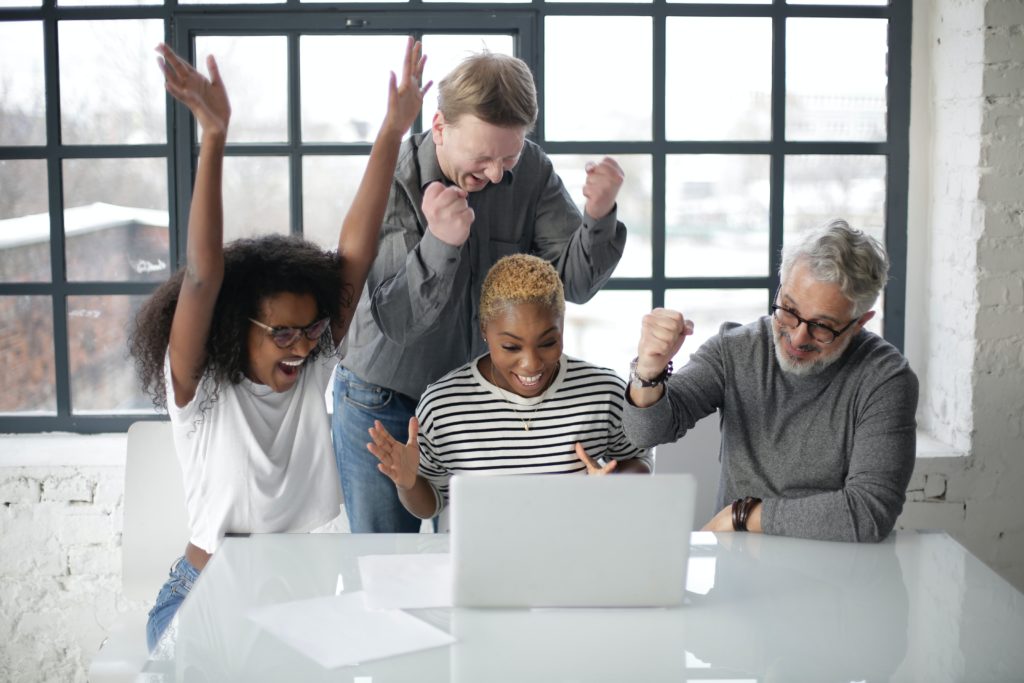 people celebrating in office